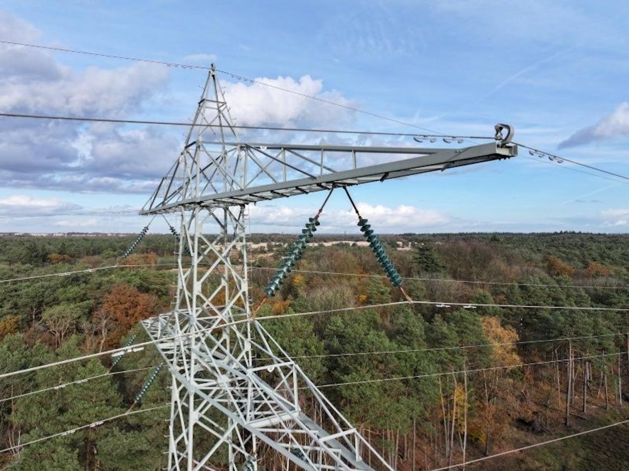 Power transmission tower over forested area