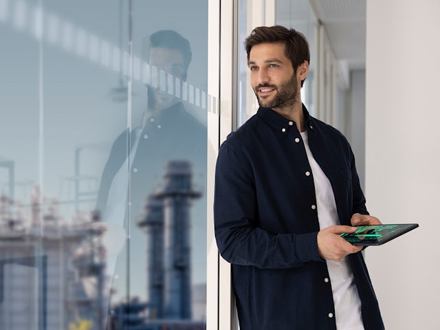 Person using touchscreen interface on industrial control panel