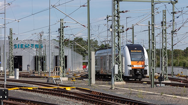 A rail project construction site with workers and machinery in progress.