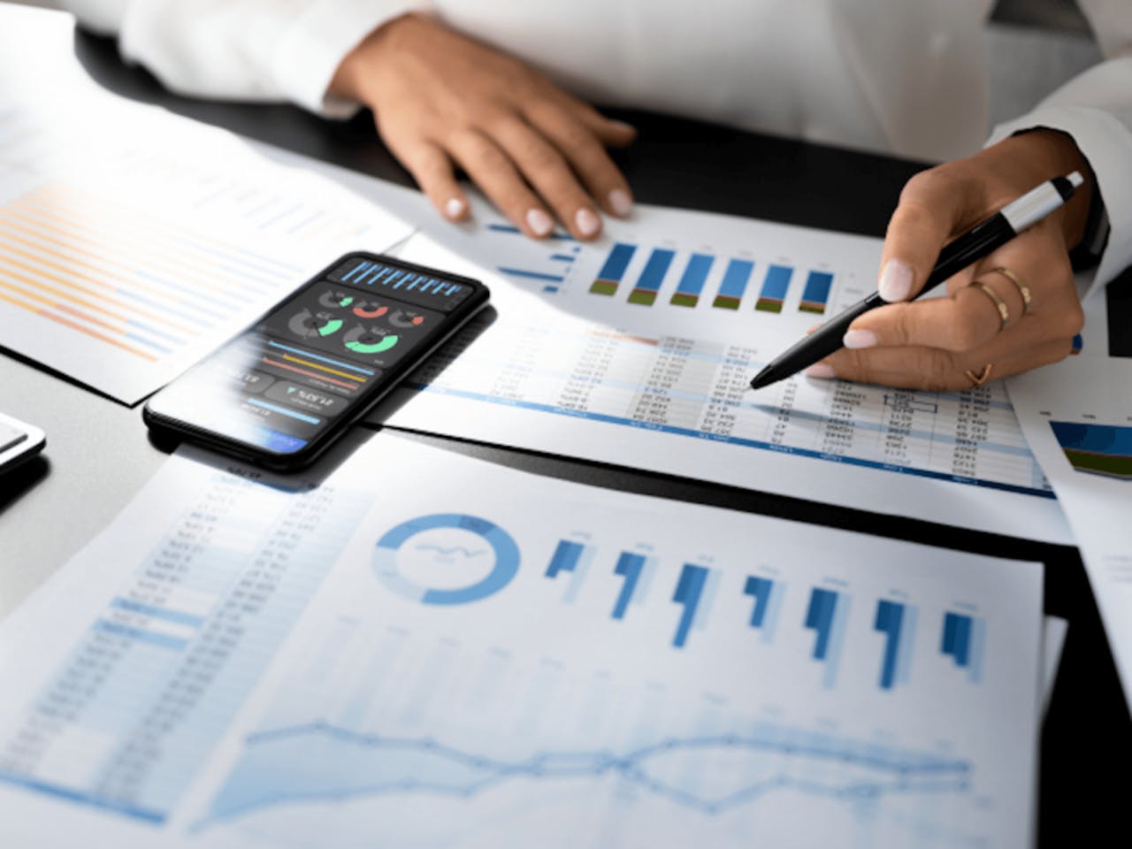 Person analyzing financial charts and graphs