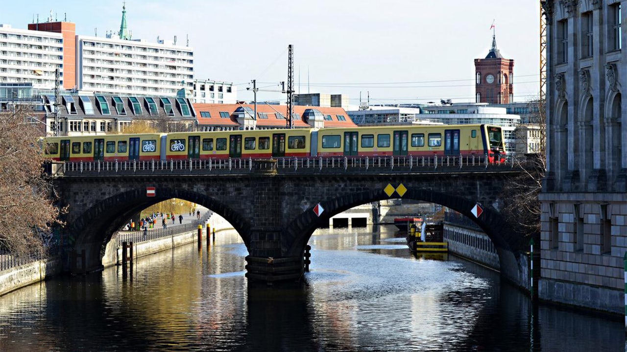 A Berlin S-Bahn train is shown on a track with a spectrum power case study in the background.