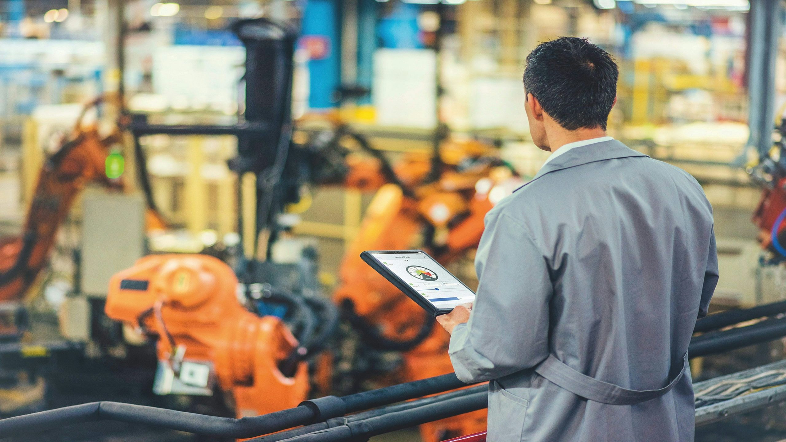 Worker oversees production line.
