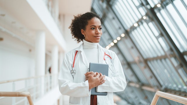 woman doctor walking down a hospital hallway