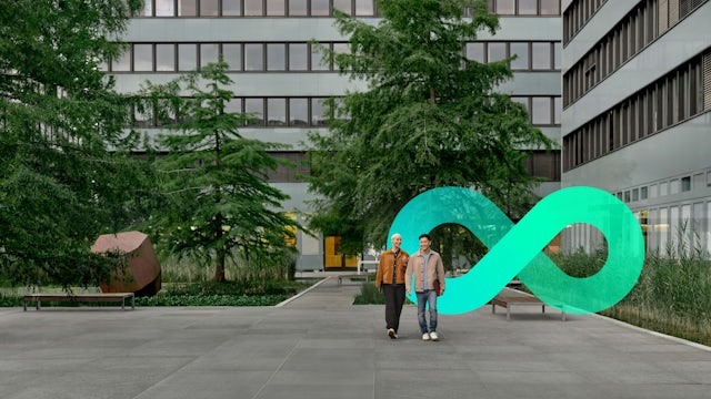 Two people walking outside of an office building with an infinity symbol in the background.