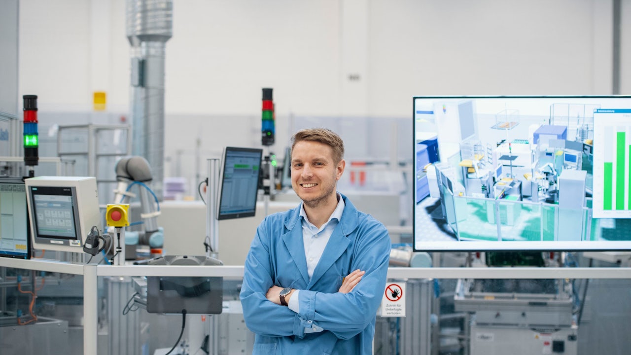 Factory worker operating machinery in an electronics manufacturing facility