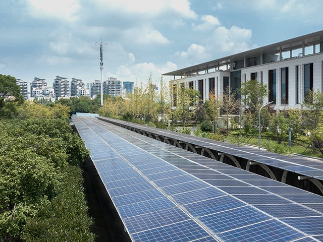 The image shows a building with solar panels installed on its roof.