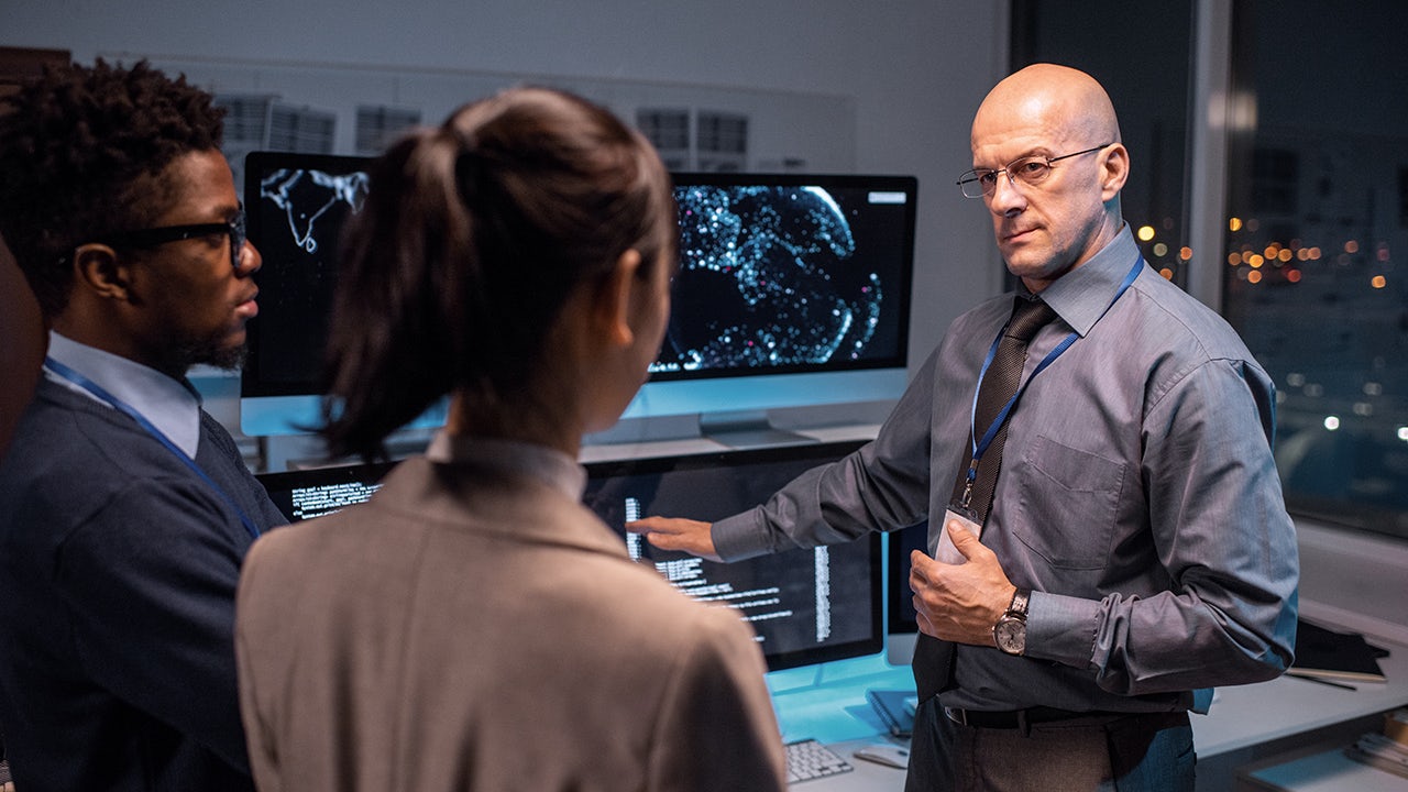 Man works with futuristic grid security system.