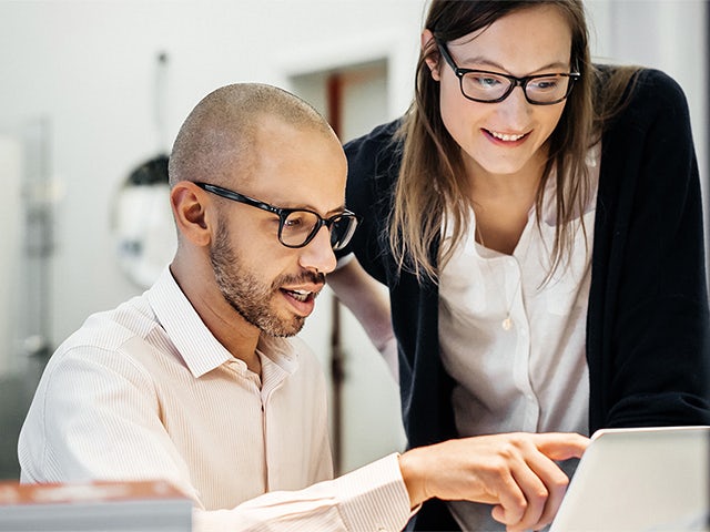 The image shows a software platform as a service product promo with a person in the background.