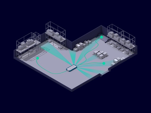Robot performs task in automative production facility.