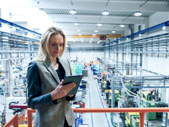Woman in a factory using a tablet.