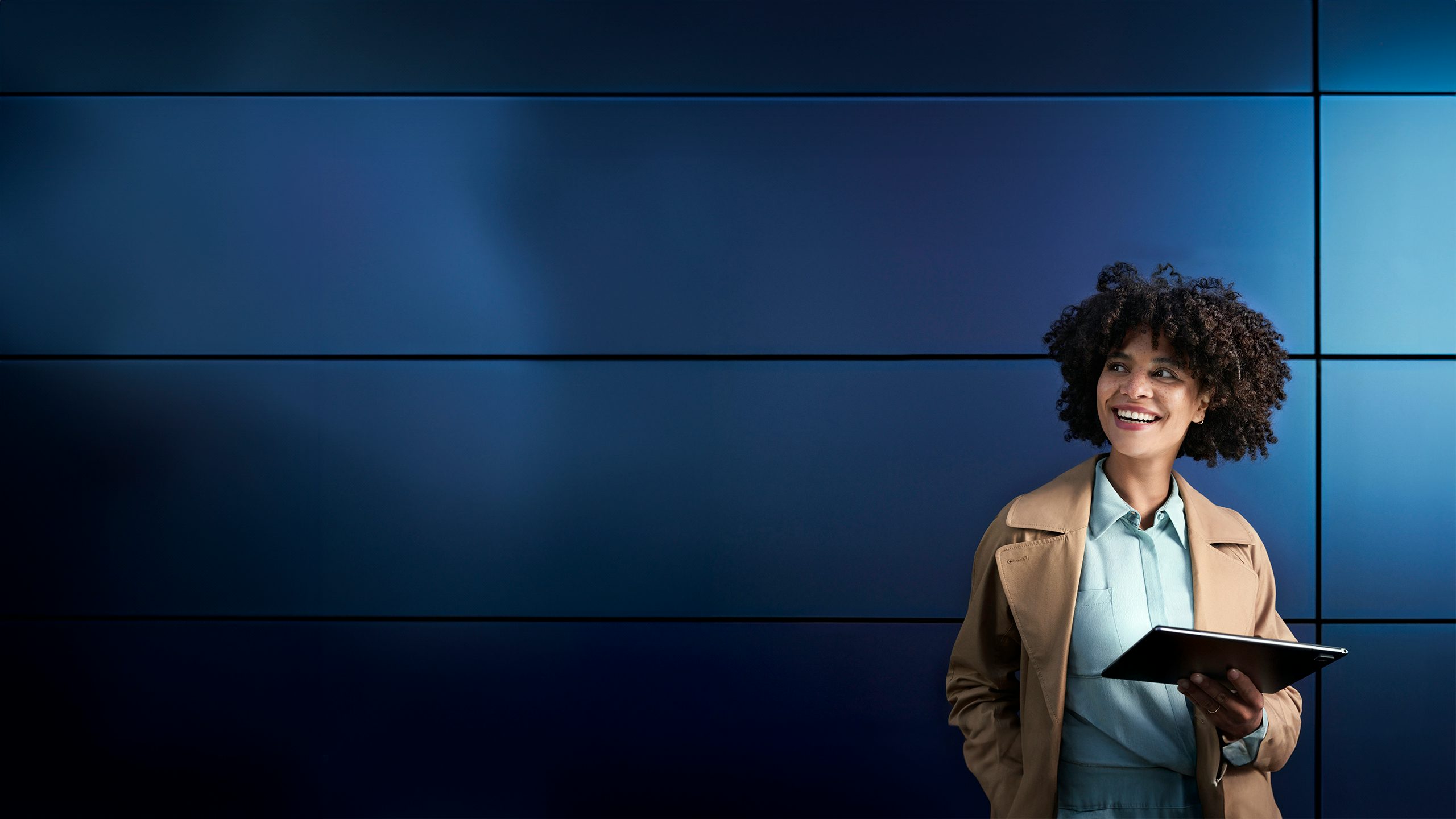 A woman holding a tablet.
