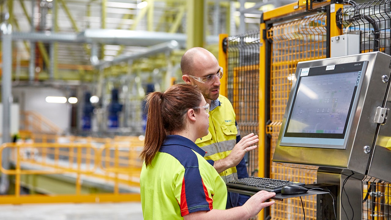 A factory warehouse with workers in a digital transformation process.