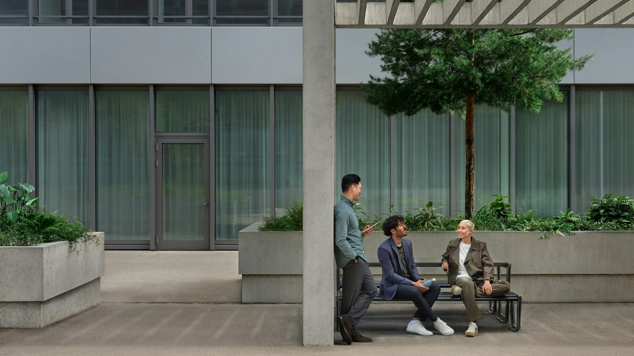 Young people in green environment and officebuilding