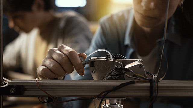 Student working on a 3D printer.