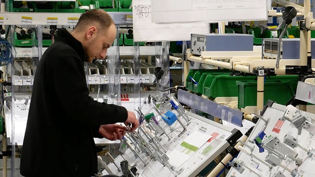 A digital twin simulation of a wire harness plant with a focus on the manufacturing process.