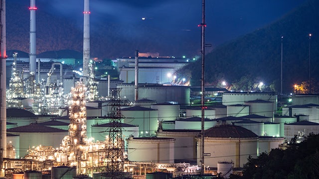 A large industrial facility with multiple tanks and pipelines, possibly a refinery or chemical plant.
