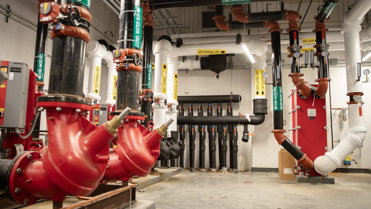 Mechanical room in the UTSC basement featuring insulated pipes, pumps, and energy‑efficient building systems used for campus heating and cooling infrastructure. (uuid:7edcb64a-33a9-4ecb-883e-5d1139fce85a)