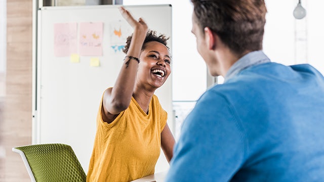 Students give each other high-fives.